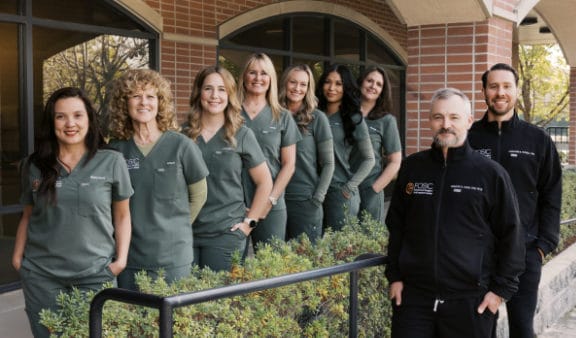 Back office staff standing in front of the building