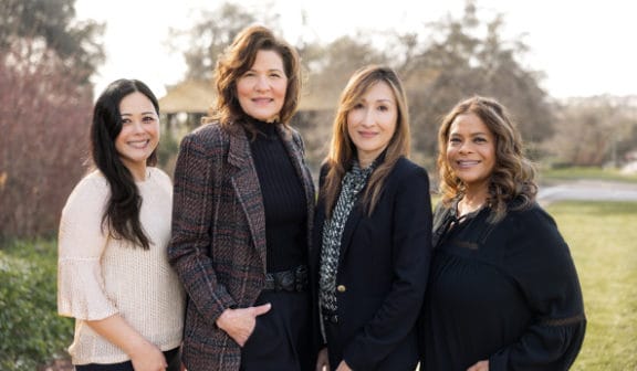 Back office staff standing in front of the building